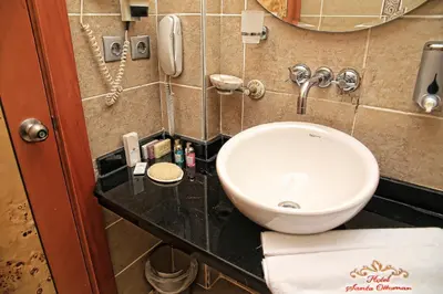 a bathroom with a sink and a phone at Santa Ottoman Hotel in Istanbul
