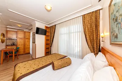 a hotel room with a bed and a desk at Santa Ottoman Hotel in Istanbul
