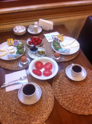 a table with plates of food on top of it at Kosk Hotel Kadikoy in Istanbul