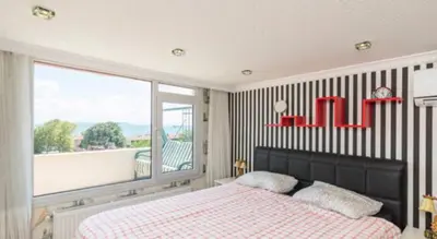 a bedroom with a bed and a large window at Front of Sea View Apartments Sultanahmet SEA VIEW in Istanbul