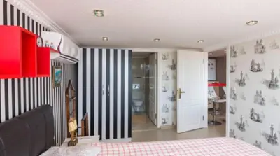 a bedroom with a black and white striped wall at Front of Sea View Apartments Sultanahmet SEA VIEW in Istanbul