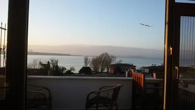 a balcony with chairs and a view of the water at Front of Sea View Apartments Sultanahmet SEA VIEW in Istanbul