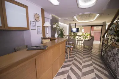 a bar in a salon with a counter and a staircase at Cumbali Suite Hotel in Istanbul