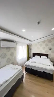 a bedroom with two beds and a window at The Lola Hotel in Istanbul