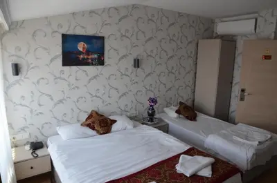 two beds in a room with white walls at The Lola Hotel in Istanbul