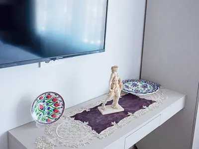 a shelf with a statue and two plates on it at The Lola Hotel in Istanbul
