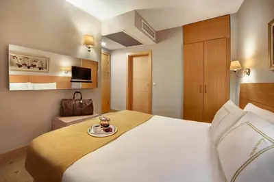 a hotel room with a bed with a tray of food on it at Almina Hotel - Special Class in Istanbul