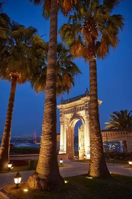 a building with palm trees in front of it at Çırağan Palace Kempinski Istanbul in Istanbul