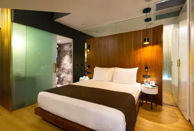 a bedroom with a large bed and a glass wall at The Craton Hotel Sisli in Istanbul