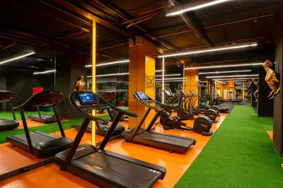 a gym with a row of treadmills and exercise bikes at The Craton Hotel Sisli in Istanbul