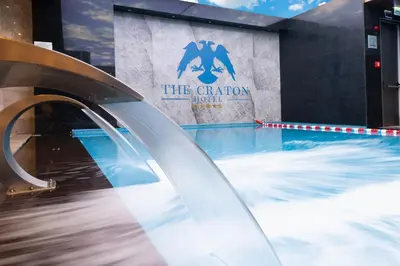 a pool with a water slide in front of a building at The Craton Hotel Sisli in Istanbul
