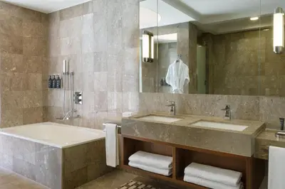 a bathroom with two sinks and a tub and a mirror at Sheraton Bursa Hotel in Bursa