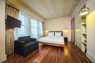 a hotel room with a bed and a chair at The Haze Karaköy in Istanbul