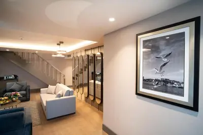 a living room with a picture of birds on the wall at Arts Hotel Taksim in Istanbul
