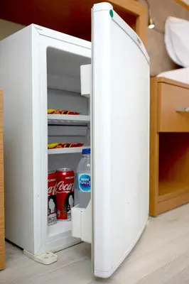 an open refrigerator with drinks inside of it at Kartal Palace Taksim Square FAMILY HOTEL in Istanbul