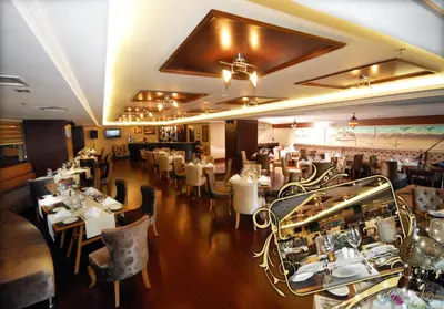 a restaurant with tables and chairs in a room at Dream Hill Business Deluxe Hotel Asia in Istanbul