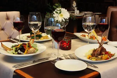 a table with plates of food and glasses of wine at Dream Hill Business Deluxe Hotel Asia in Istanbul