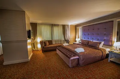 a hotel room with a large bed and a chair at Dream Hill Business Deluxe Hotel Asia in Istanbul