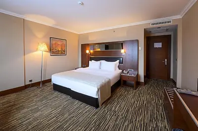 a large hotel room with a bed and a lamp at Dream Hill Business Deluxe Hotel Asia in Istanbul