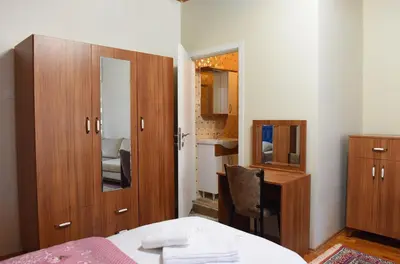 a bedroom with a bed and a desk and a mirror at ÖZ Butik Otel Antik Kent Myrleia in Mudanya
