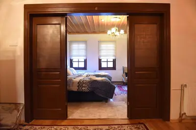 a door leading into a bedroom with a bed at ÖZ Butik Otel Antik Kent Myrleia in Mudanya