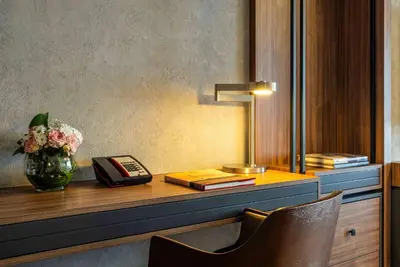a desk with a telephone and a vase of flowers at Ramada Plaza By Wyndham Istanbul Tekstilkent in Istanbul