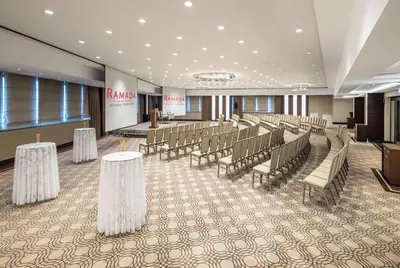 a conference room with tables and chairs and a podium at Ramada Plaza By Wyndham Istanbul Tekstilkent in Istanbul