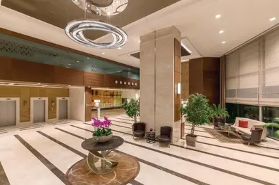 a lobby of a hotel with a table and flowers at Ramada Plaza By Wyndham Istanbul Tekstilkent in Istanbul