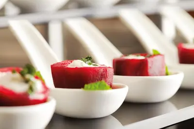 a group of red food in white bowls on a shelf at Ramada Plaza By Wyndham Istanbul Tekstilkent in Istanbul