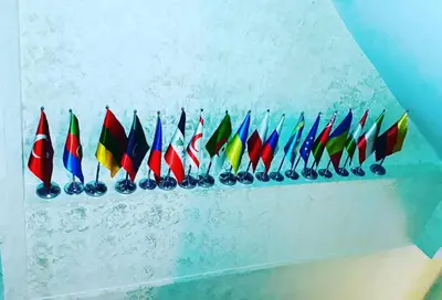 a row of different colored flags on a wall at Hivas Hotel in Istanbul