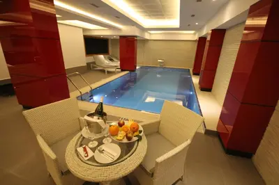 a room with a table and a swimming pool at Grand Washington Hotel in Istanbul