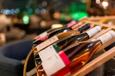 a row of wine bottles on a wooden shelf at Grand Washington Hotel in Istanbul