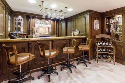 a bar in a home with wooden cabinets and stools at Golden Crown Hotel in Istanbul