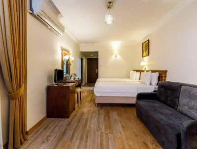 a hotel room with a bed and a couch at Golden Crown Hotel in Istanbul