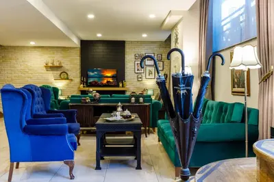 a living room with blue couches and umbrellas at Golden Crown Hotel in Istanbul