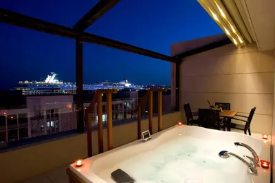 a bath tub on a balcony with a view of a ship at Nidya Hotel Galataport in Istanbul