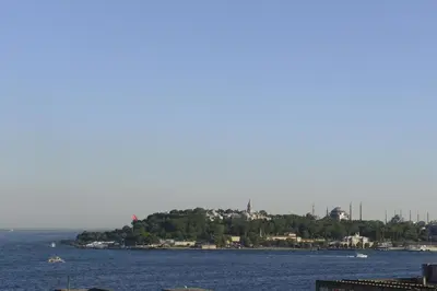 a view of a body of water with houses on a hill at Nidya Hotel Galataport in Istanbul