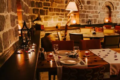 a table in a restaurant with a table set for dinner at Misgibi Hotel in Bursa