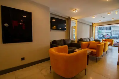a waiting room with couches and orange chairs at Avrasya Port Hotel in Istanbul