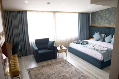 a bedroom with a bed and a chair at Avrasya Port Hotel in Istanbul