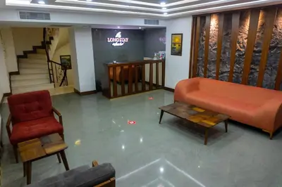 a living room with a couch and a chair at Long Stay İstanbul Hotel in Istanbul