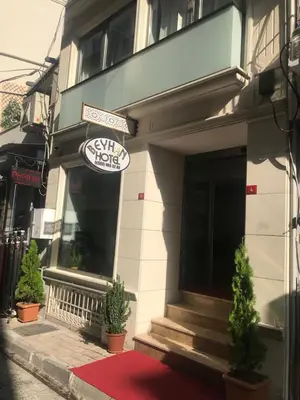 a restaurant with a red rug in front of a building at Beyhan Hotel in Istanbul