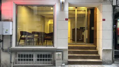 a building with chairs and tables in a window at Beyhan Hotel in Istanbul