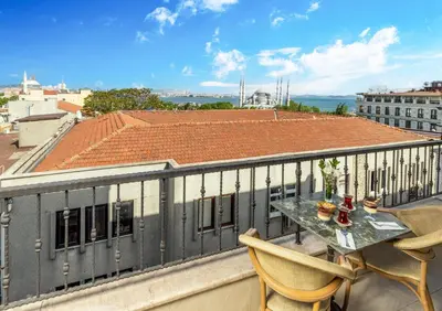 a balcony with a table and chairs on a roof at Rast Hotel Sultanahmet in Istanbul