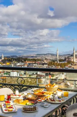 a table with plates of food on a balcony at Rast Hotel Sultanahmet in Istanbul