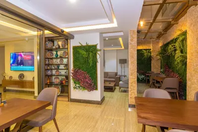 a dining room with tables and chairs and a green wall at 38 Hotel in Istanbul