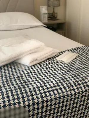 a bed with two folded towels sitting on it at My Palace Aırport in Istanbul