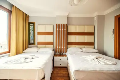 two beds sitting next to each other in a bedroom at Maduro Hotel Istanbul in Istanbul