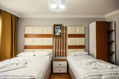 two beds sitting next to each other in a bedroom at Maduro Hotel Istanbul in Istanbul