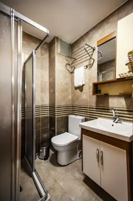 a bathroom with a toilet and a sink at Maduro Hotel Istanbul in Istanbul